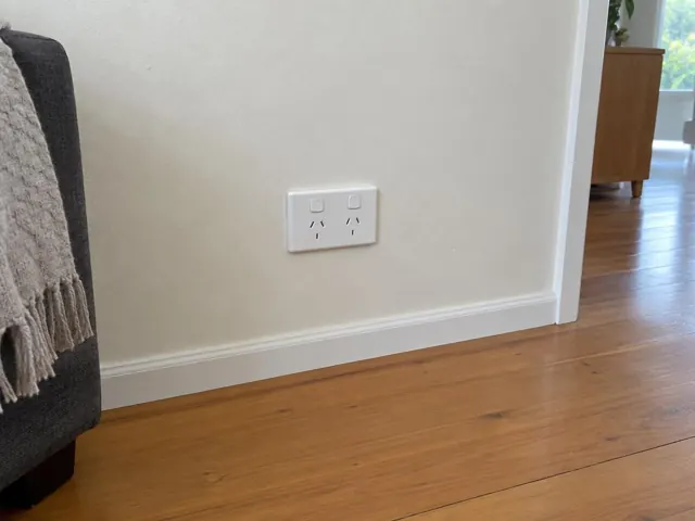 White double power point on a painted wall above timber floorboards in a modern home in Carey Bay
